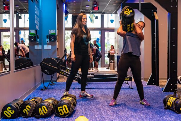 Coach and member working out