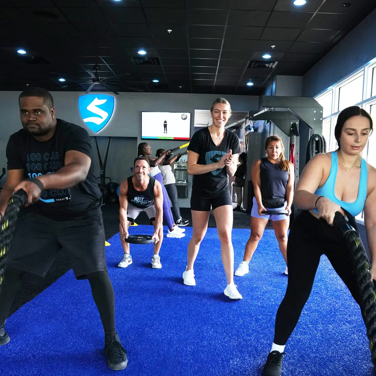SWEAT440 members training with battle ropes during a conditioning class