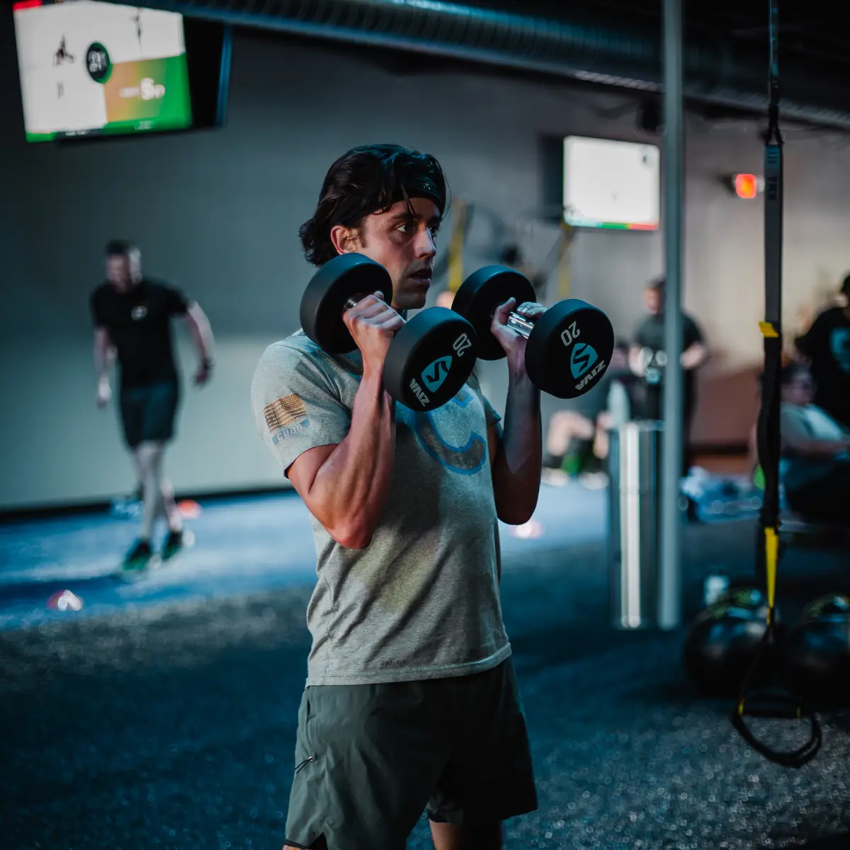 Man doing dumbbell curls during a SWEAT440 strength workout