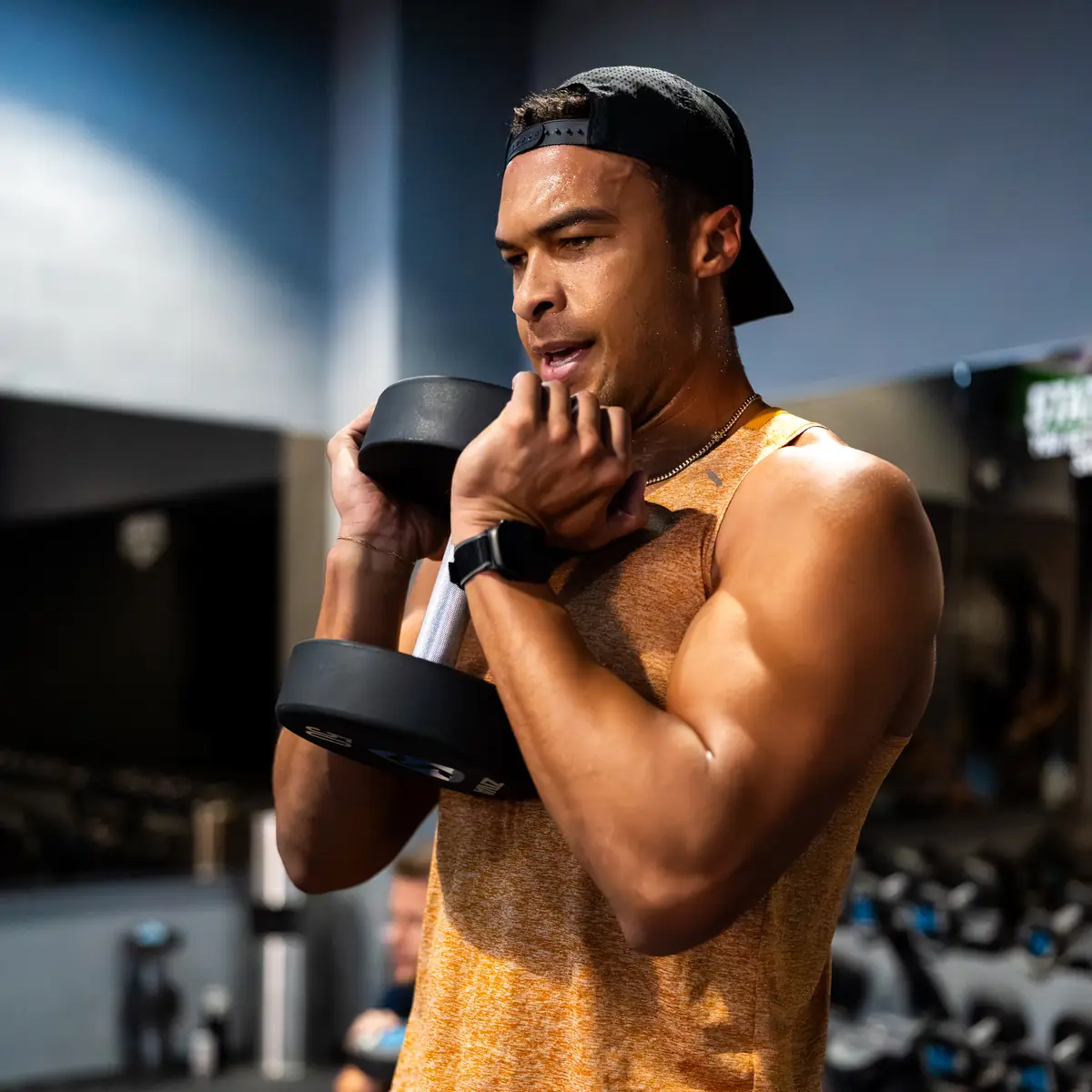Man holding a dumbbell during a SWEAT440 strength training class