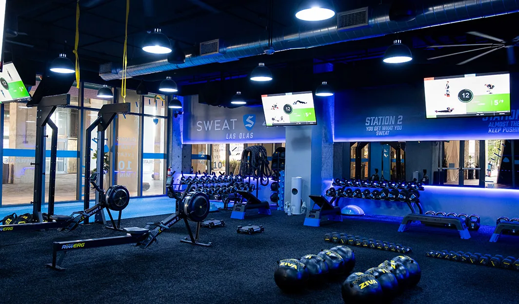 Inside a SWEAT440 franchise studio with training stations and equipment ready for class