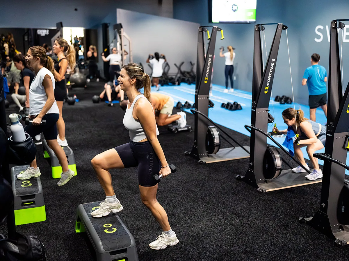 SWEAT440 members doing step-ups on boxes during a flex-time class