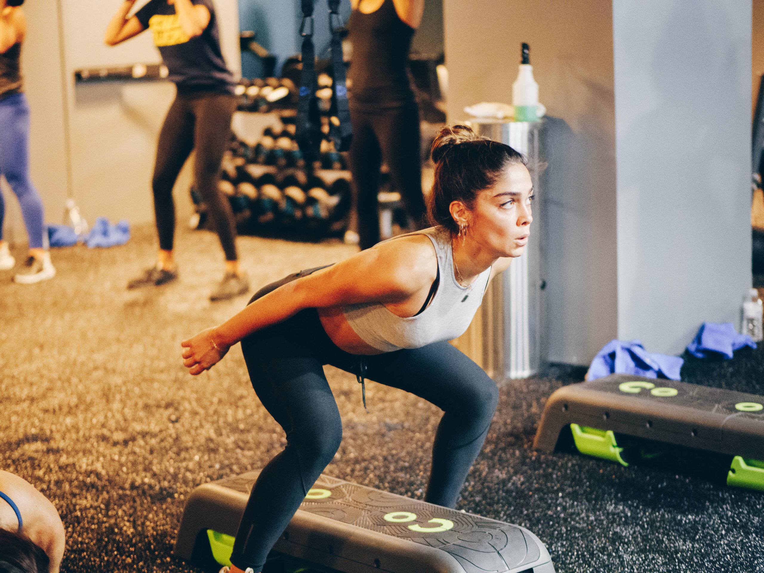 Woman doing a squat at fitness studio